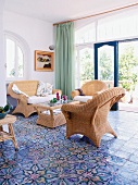 Living room with antique floor tiles and wicker furniture