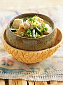 Close-up of Gaeng Keow Wahn Gai green chicken curry in serving bowl