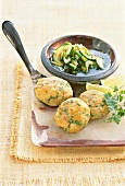 Close-up of Tod Mun Plaah fish cakes on plate and cucumber dip in bowl