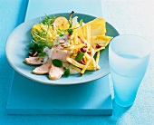 Apple chicory salad with yogurt lemon balm in blue plate