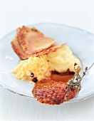 Close-up of stuffed duck with potatoes and pineapple pesto on plate