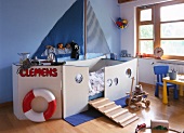 Children's room with ship shaped bed and toys around