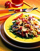 Chili chicken with spring onion and pine nuts on plate