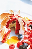 Close-up of marquise with cherries and berries on plate