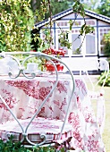 Close-up of garden table with table cloth and chairs in garden
