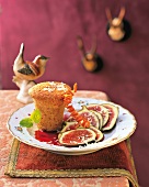 Gingerbread pudding with slices of figs and grape sauce on plate