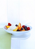 Fruit salad with vanilla cream for breakfast on plate