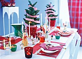 Table with Christmas tree, human figured candle stand and other decorations