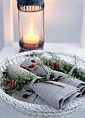 Wrapped napkins in wicker basket at Christmas table for decoration