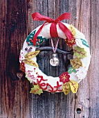 Close-up of Christmas wreath of wool, felt and beads hanging on door