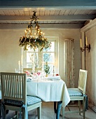 Dinning room decorated with Christmas decoration, wreath hanging from the ceiling