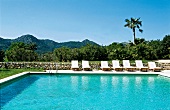 View of deckchairs at swimming pool of Hotel Rural Son Gener at Majorca