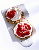 Crisp bread with cream fraiche and strawberry jam on board