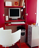 Computers in hall closet with drawers and chair