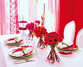 Dining table decorated with red flowers