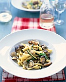 Strozzapreti, zucchini and mussels on plate