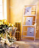 Drawer element with photo frames against yellow wall