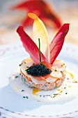 Close-up of scallops garnished with caviar on plate