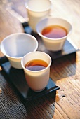 Cups with black tea on wooden table