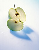 Halved apple on white background