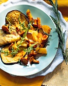 Fried eggplant with potato and mushrooms on plate