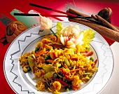 Curry noodles with scampi carrots and bean sprouts on plate, Euro-Asian cuisine