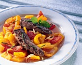 Peppers with tomato and lamb fillet on dish