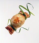Close-up of cracker of puff pastry with cheese and cocktail sausages on white background