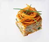 Close-up of diced vegetables of carrots, zucchini and butter cheese on white background