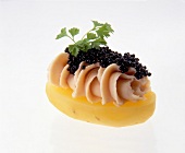 Close-up of potato snacks with trout, mascarpone and caviar on white background