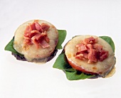 Eggplant topped with tomato, mozzarella and ham on white background