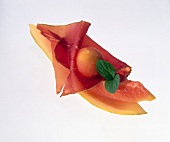 Close-up of papaya with bovine meat and smoke mint on white background