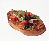 Close-up of tomato toast with salad and garlic on white background