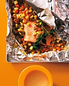 Salmon and vegetables with hollandaise sauce on foil