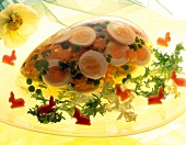 Chicken aspic with eggs and carrots on plate