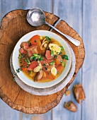 Lamb stew in bowl on tree stump