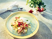 Strawberries and mango slices on glass plate