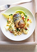 Sea bream rolls with cauliflower and couscous salad on plate