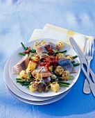 Fish salad with green beans on plate