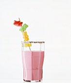 Strawberry milk in glass on white background