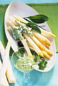 Asparagus with green sauce and egg in serving dish