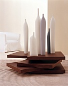 Various sizes of candle on stack of wood in living room