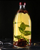 Basil and sundried tomatoes with porcini oil in glass bottle