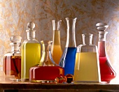 Colourful bottles with different homemade fruit liqueurs