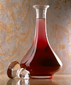 Cinnamon and blueberries with blueberry liqueur in bulbous glass bottle