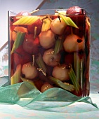 Sweet-sour pickled pears with cinnamon, cloves and mustard seeds in glass jar