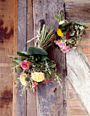 Fresh bouquets hanging on wooden wall
