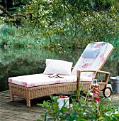 Wicker sun lounger with wheels in garden