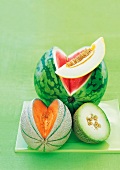 Honeydew melon, galia melon, watermelon and cantaloupe on chopping board