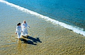 Juan Mari Arzak and Elena Arzak walking on beach, Elevated view, Spain